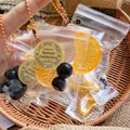Detailed view of mini fruit bag squishy toy set with orange slices and blueberries in a basket - Orange Segment / 1 Piece Pack