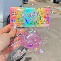 Close-up of purple cat paw pinch toy with colorful pixel art packaging - Card Head PVC Bag / Pink Crystal Large Cat Paw