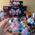 Macro view of a soft fuzzy cat paw squishy toy featuring a pink checkered ribbon bow - Card Head PVC Bag / Flocked Black Pink Dot Bow Cat Paw