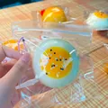 Close-up of a slow rebound egg yolk pastry squishy toy in its clear plastic zipper bag - PVC Boxed / Daifuku Egg Yolk Pastry