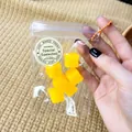 Detail view of mini mango cube squishy toys in a clear packaging bag with sticker. - Mango Cube / 6 Pieces/Pack