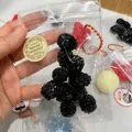 Detailed view of a realistic black raspberry squeeze toy packaged in a mini clear zipper bag - Mulberry Pieces / 10 Pieces Pack