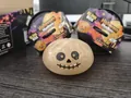 Detailed view of Halloween ghost baozi squishy toy set with mystery blink box packaging - Gilded Skull