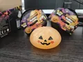Detailed view of a soft Halloween pumpkin squishy toy and its mystery blind box - Jack-o'-lantern