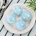 Close-up of four glittery blue handmade silicone squeeze balls on a white plate - Star and Moon Sequin Style / Set of 4 / Sky Blue