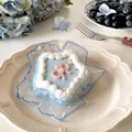 Close-up detail of a blue star-shaped cake squishy toy with pink bow decoration - Star Cake / Squishy Toy