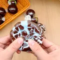 Detailed view of mint chocolate themed squishy toy being squeezed for stress relief - Sea Salt Crispy Ball