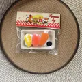 Detailed view of sushi set squeeze toy in packaging for stress relief - Salmon Sushi Style