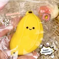 Close-up of a large yellow banana-shaped squishy toy for stress relief with a smiley face. - Simulation Banana Yellow