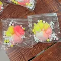Close-up of a giant 11cm cat paw slow rebound squishy toy in its transparent bag - 11-12cm Oversized / Rainbow Gradient