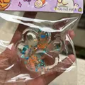 Detail showing texture of starry cat paw squishy toy with colorful sequins inside - Starry Sky Transparent Cat Paw