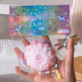 Detailed view of a pink donut-shaped squishy toy in its colorful pinch family packaging - Sequin Cake / Pink