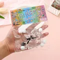Detailed view of a cute paw-shaped squishy toy in colorful pixel-art style packaging - Clear Cat Paw
