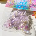 Detail of purple glitter cat paw squeeze toy decorated with pearls and butterfly - Purple Crystal Cat Paw / Purple