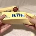 Close-up of hands squeezing a realistic salted butter stick slow rebound squishy stress toy - Butter Stick (Painted Style)