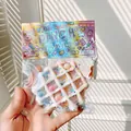 Close-up of waffle-shaped squeeze toy with colorful sprinkles in clear packaging - Blue Pink White Waffle