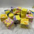 Detail view of marble patterned colorful cheese cube squishy toys on white fur carpet. - Marble Pattern Cheese / 7cm
