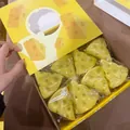 Detail showing a box of realistic cheese-shaped slow-rebound squishy stress toys - Large / Triangle Cheese