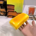 Detailed close-up view of a long yellow cheese bread squishy toy for stress relief - Long Cheese Rice Cake Style