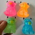 Detailed view of colorful TPR highland cow squeeze toys in pink, orange, green, and blue - Highland Cow / 8x6cm / Maltose Black Horn Cow Pink