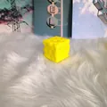 Macro detail of a bright yellow cheese-shaped slow rebound squishy toy on white faux fur. - Classic Cheese / 5cm