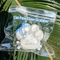White cat paw squishy stress relief toy decorated with a blue bow in a clear bag - White Moonlight Cat Paw / 7x7cm