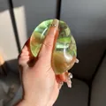 Close-up detail of a transparent green maltose squishy decompression toy being squeezed by hand - Maltose Ball / 6cm / Muscat Green