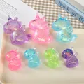 Seven glittery unicorn squishy toys in various vibrant colors on a white tray - Large Unicorn / Medium