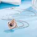 Close-up of heart projection necklace in rose gold with LOVE engraving - Three-Diamond Heart Projection Style / Rose Gold