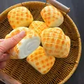 Detailed close-up of a slow rebound squishy toy shaped like a realistic pineapple bun. - Large / Pineapple Bun