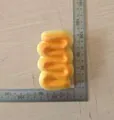 Soft PU foam simulation bread squishy toy being measured with a metal ruler for size reference - Large / Cream Bar (SZ00069)