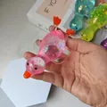 Glitter-filled translucent duck stress relief squeeze toy in multiple vibrant colors - Pink Duck