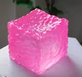Vibrant pink cube-shaped squishy stress relief toy featuring a unique water ripple texture - Honeycomb Wave Ice Cube [Pink] OPP Bag