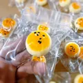 Detailed view of mini salted egg yolk bun squishy stress toy in clear plastic bag. - Mini Style With Chain