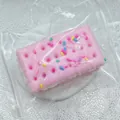 Detailed macro view of a pink soda sandwich biscuit squishy toy in clear packaging - Soda Sandwich Cracker / Pink