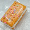 Macro view of realistic soda sandwich biscuit squishy toy with colorful sprinkles texture - Soda Sandwich Cracker / Brown