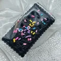 Detailed macro view of black sandwich biscuit squishy toy with colorful sprinkles texture - Soda Sandwich Cracker / Black