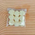 Detailed close-up view of nine coconut milk cube squishy toys in a clear plastic zip bag - Nine Cat Claws (Coconut) / 9 Pieces Set