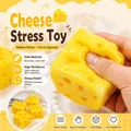 Detail view of a hand squeezing a soft yellow cheese-shaped slow rebound squishy toy - Cheese Shape / Yellow