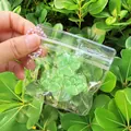 Detailed view of three mini green translucent cat paw squishy toys in a clear bag. - Set of 3 / Green