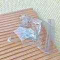 Macro view of transparent water cube squishy toy for stress relief in a plastic bag - Cheese Shape / Clear