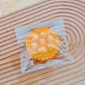 Close-up of fried food squishy toy with breadcrumb texture in clear bag - Raspberry Tart (Fried)