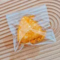 Detail of simulated fried onigiri squishy toy with breadcrumb texture in clear bag - Rice Ball (Fried)