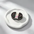 Close-up of Oreo-inspired squishy toy with colorful sprinkles and stretchy filling - Stretch Particle Oreo Style / Black