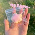 Detail view of a cute pink and white star-shaped squeeze toy pendant in a bag - Star Squishy / Pink
