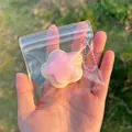 Detail view of a cute pink and white star-shaped squeeze toy pendant in a bag - Star Squishy / Pink