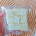 Close-up of white simulation food squishy toy cubes with textured finish in a clear bag - Nine Squares (Coconut) / 9 Pieces Set