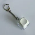 Macro detail of a mechanical keyboard switch keychain fidget toy with a white keycap. - Without Light Snake Chain / Beige
