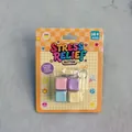 Detail view of four-key macaron colored stress relief button toy in retail packaging - Macaron Square Four-Key / With LED Lights