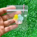 Juguete antiestrés con forma de pata de gato colorida en bolsa de plástico transparente. - Pata de Gato Arcoíris de Tres Colores